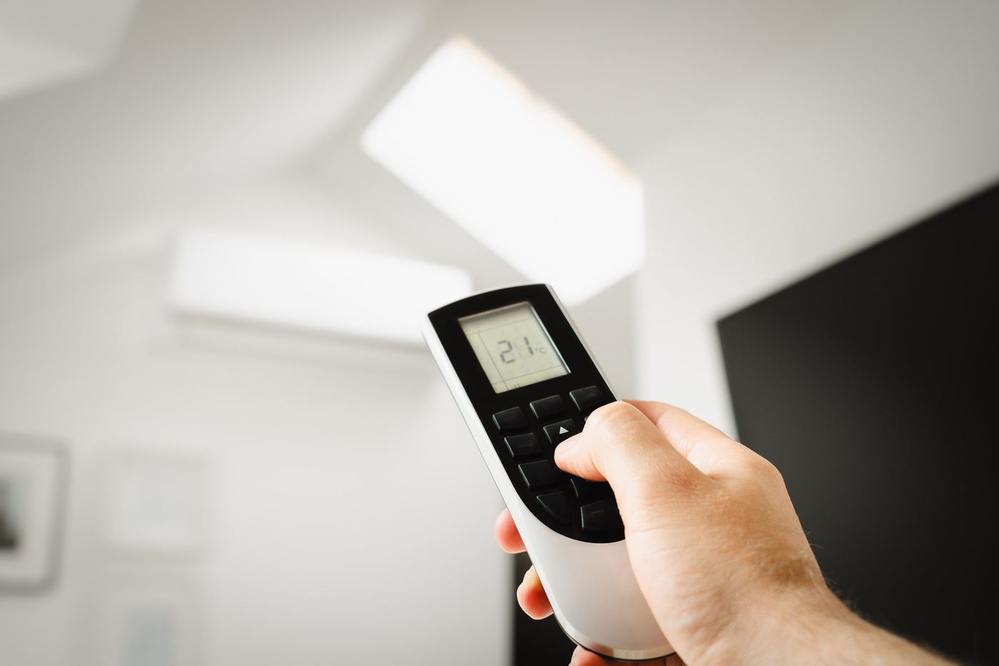 Homeowner setting the perfect temperature with a remote